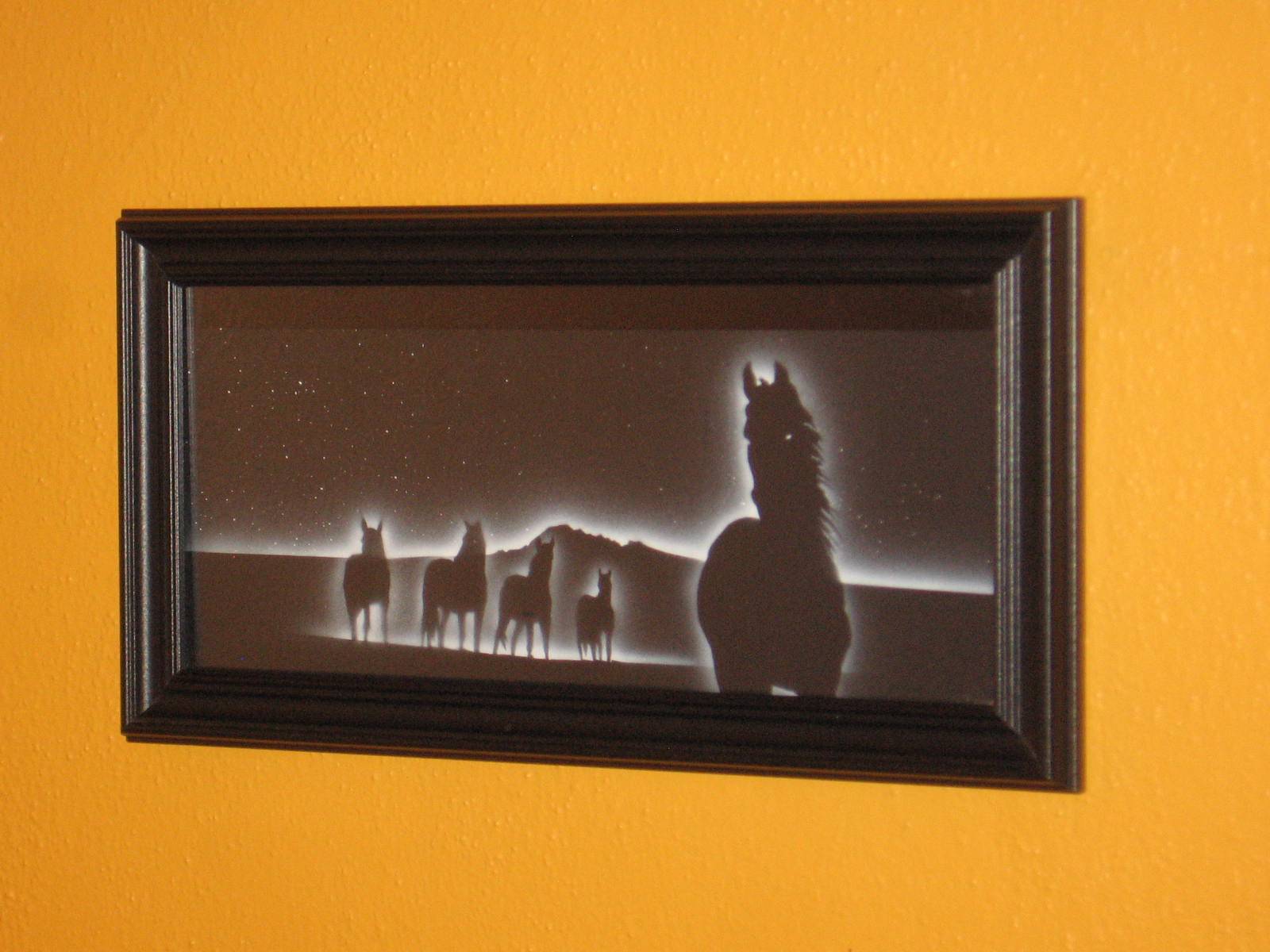 A picture of horses in the background with a horse and rider.