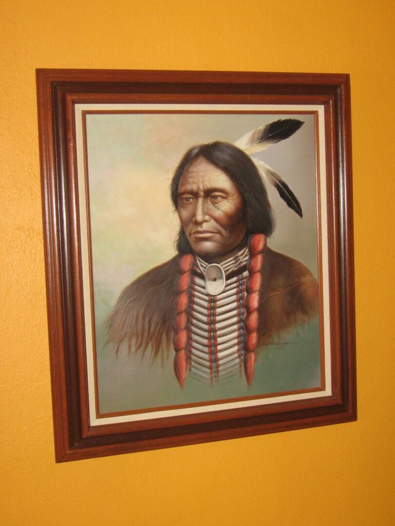 A painting of an indian on the wall.