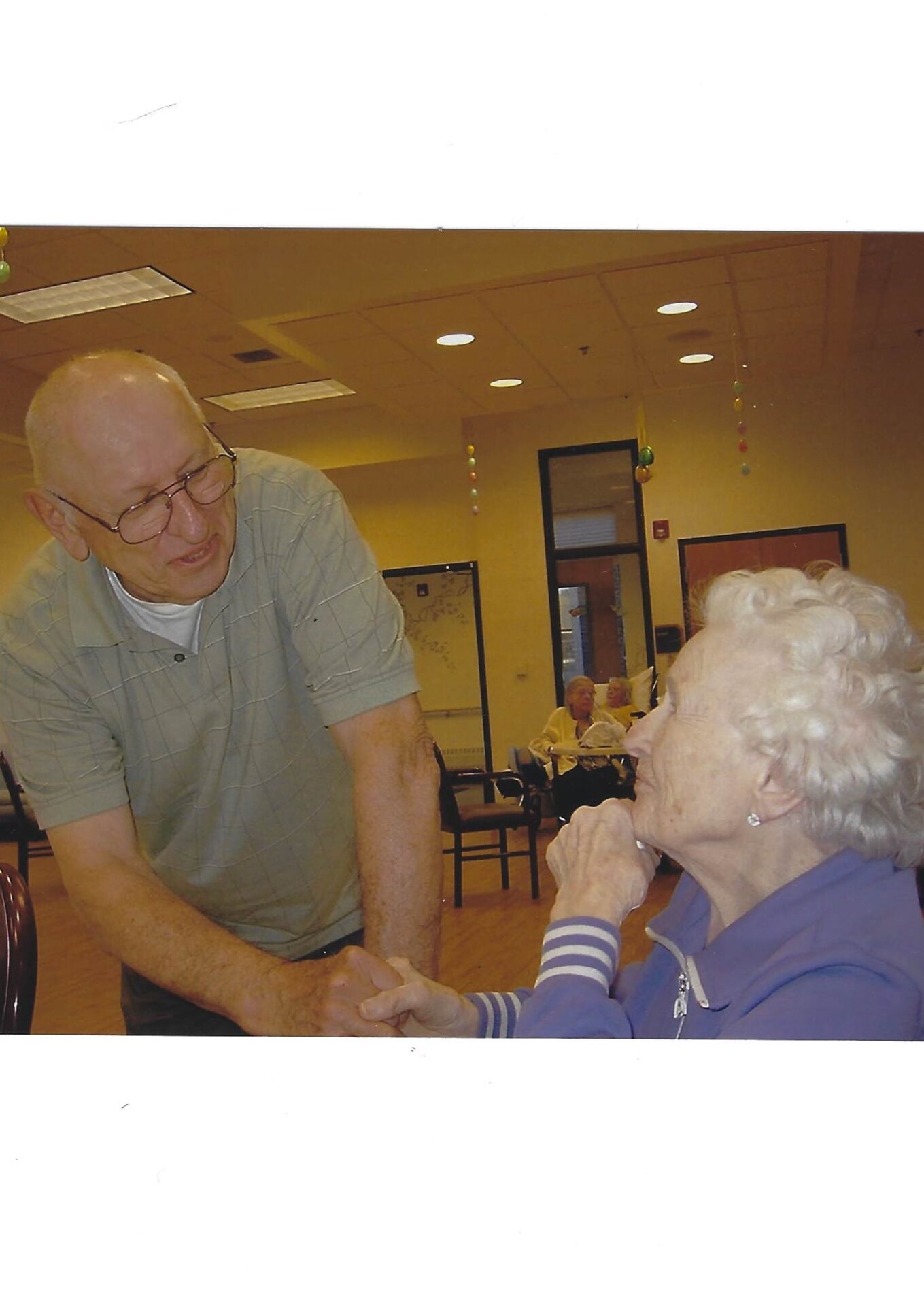 A man and woman shaking hands in an older age.