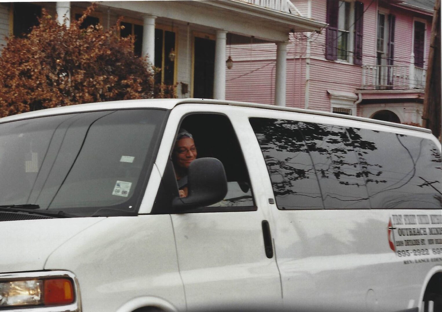 A man sitting in the driver 's seat of a van.