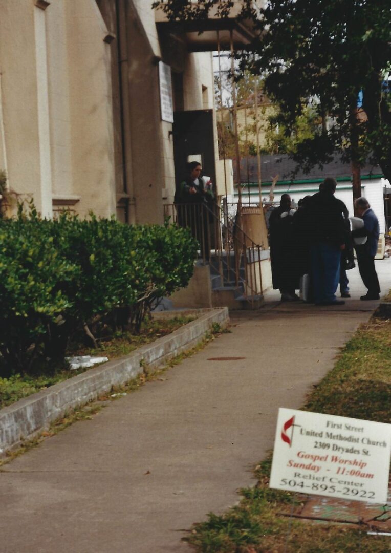 A group of people walking down the sidewalk.