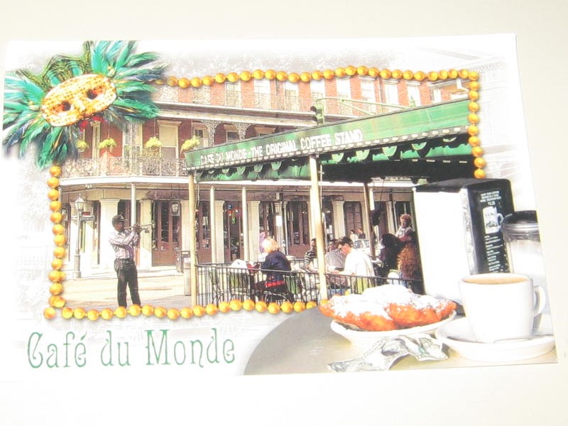 A picture of the outside of a building with people eating.