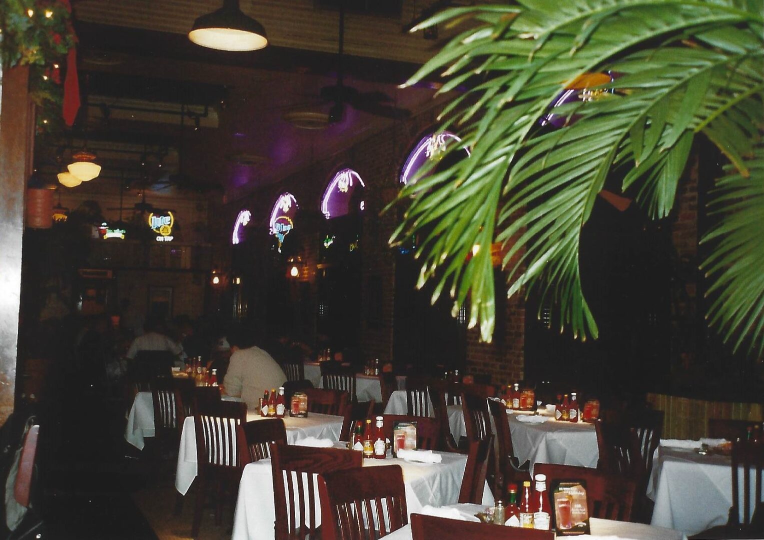 A restaurant with tables and chairs set up for dinner.