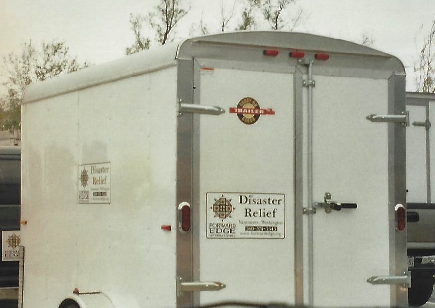 A white trailer with emergency signs on it.