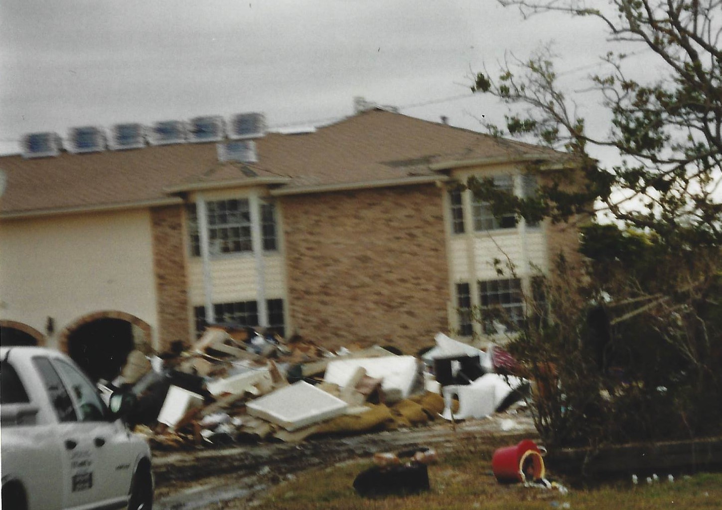 A house that is in the middle of a pile of debris.
