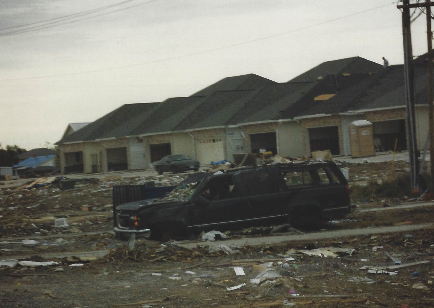 A black van parked in front of some houses