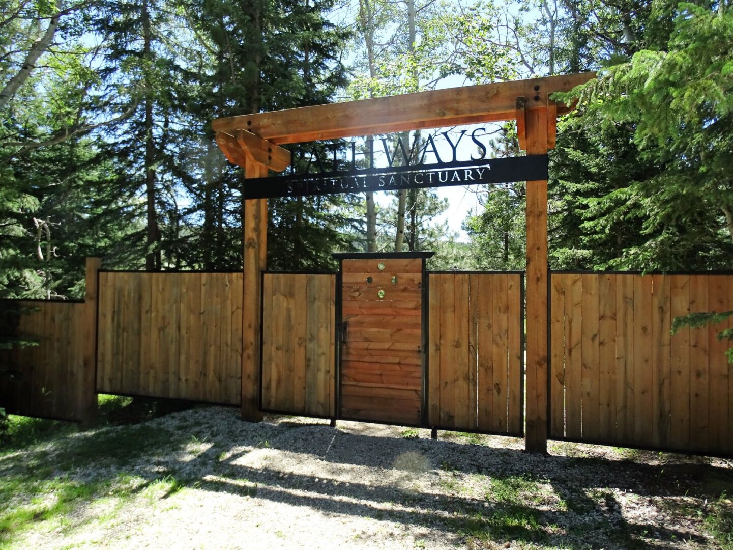 A wooden gate with a sign on it
