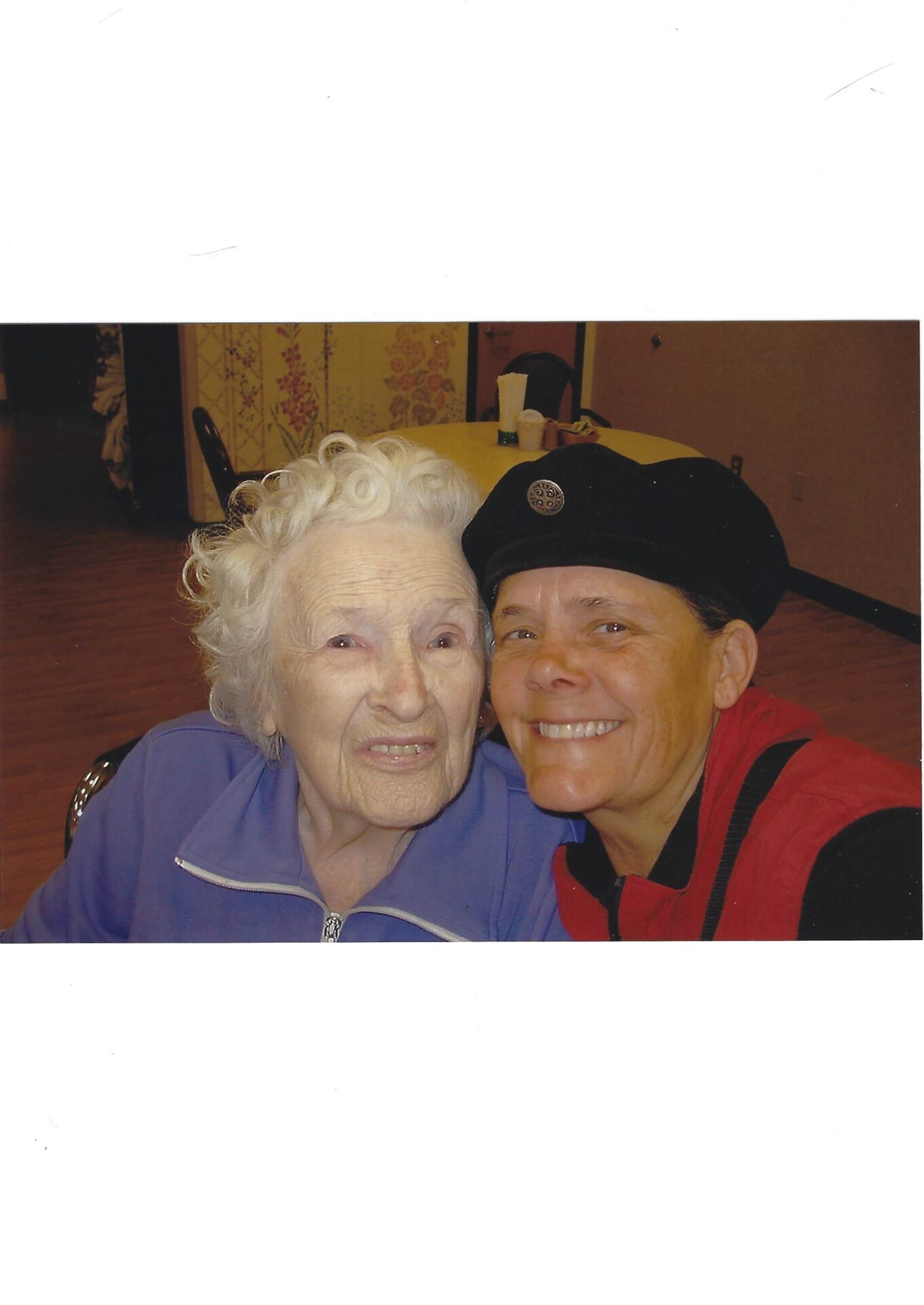 A woman and an older person smiling for the camera.