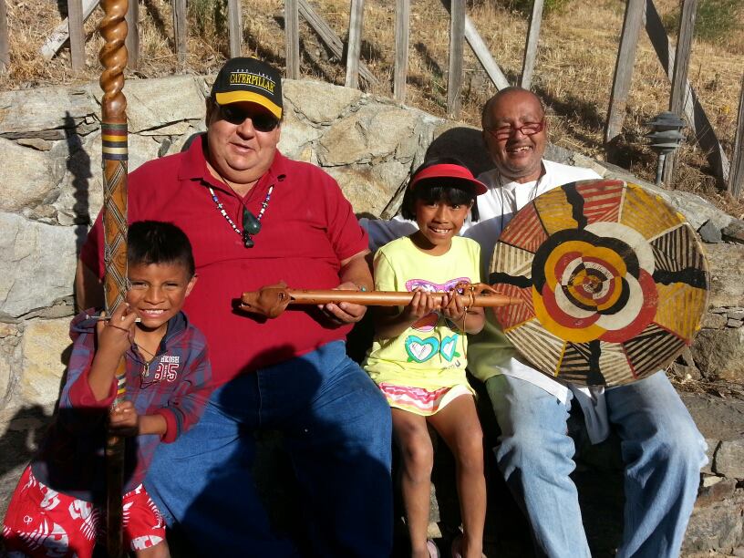 A group of people sitting on top of a rock.