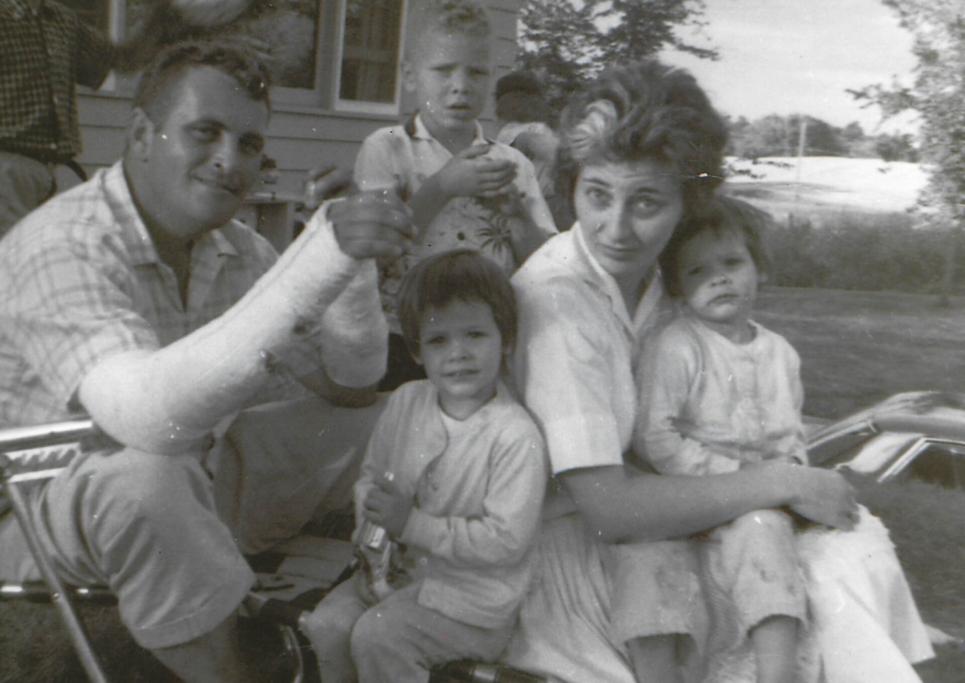 A family of five posing for the camera.