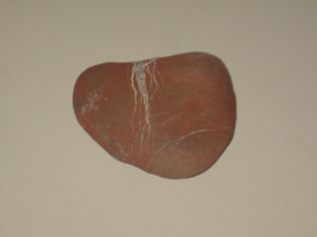 A rock with cracks on it is shown.
