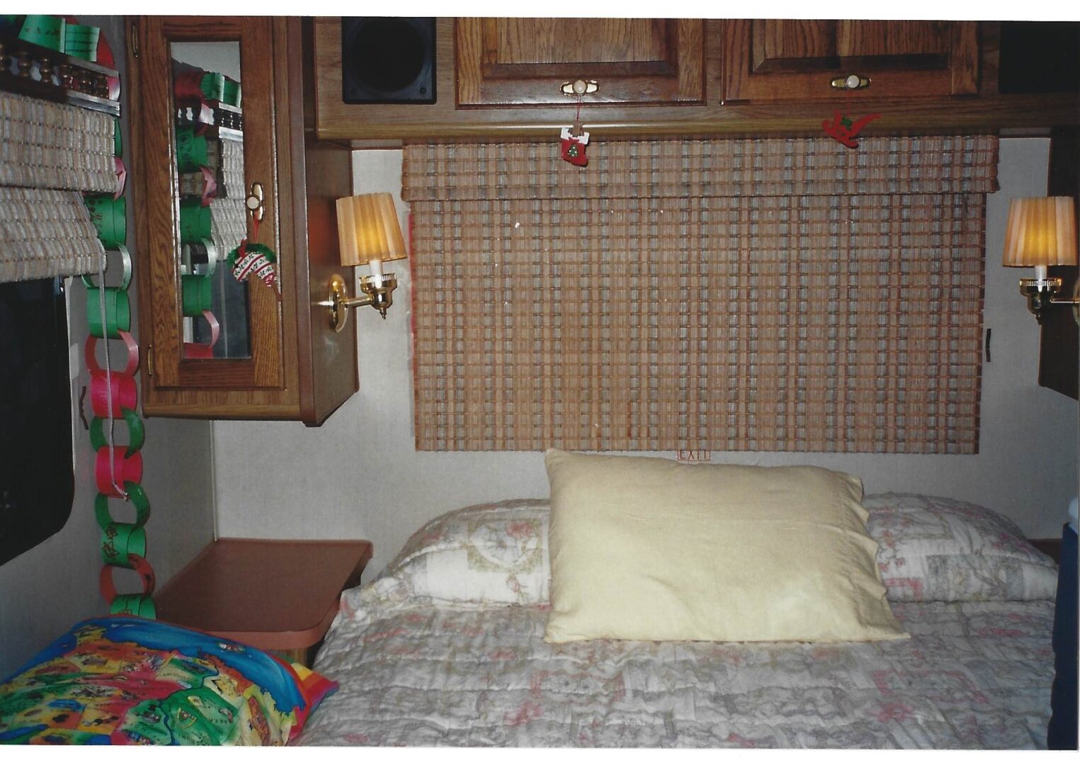 A bed with pillows and a headboard made of wood.