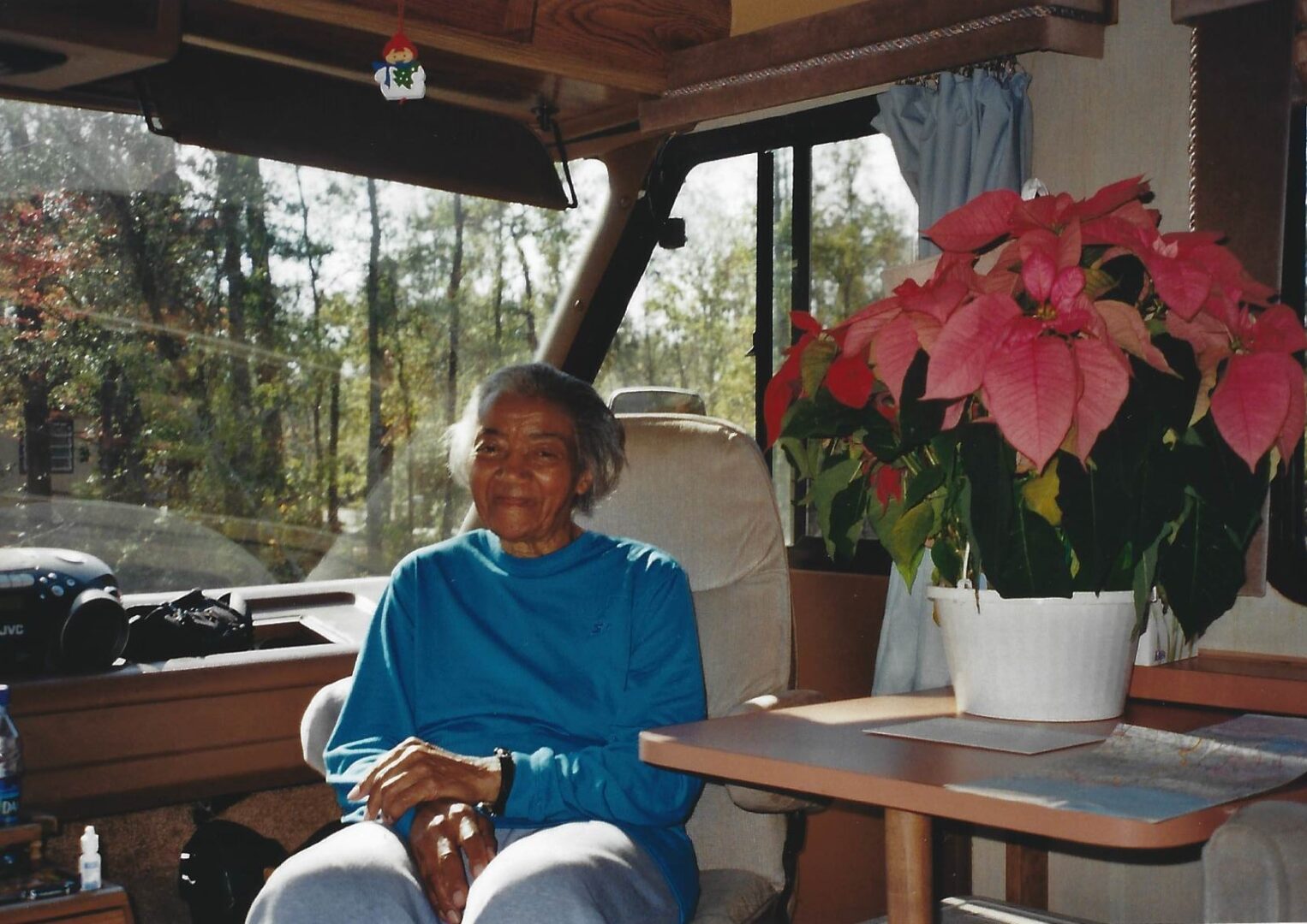 A woman sitting on the porch of her home.
