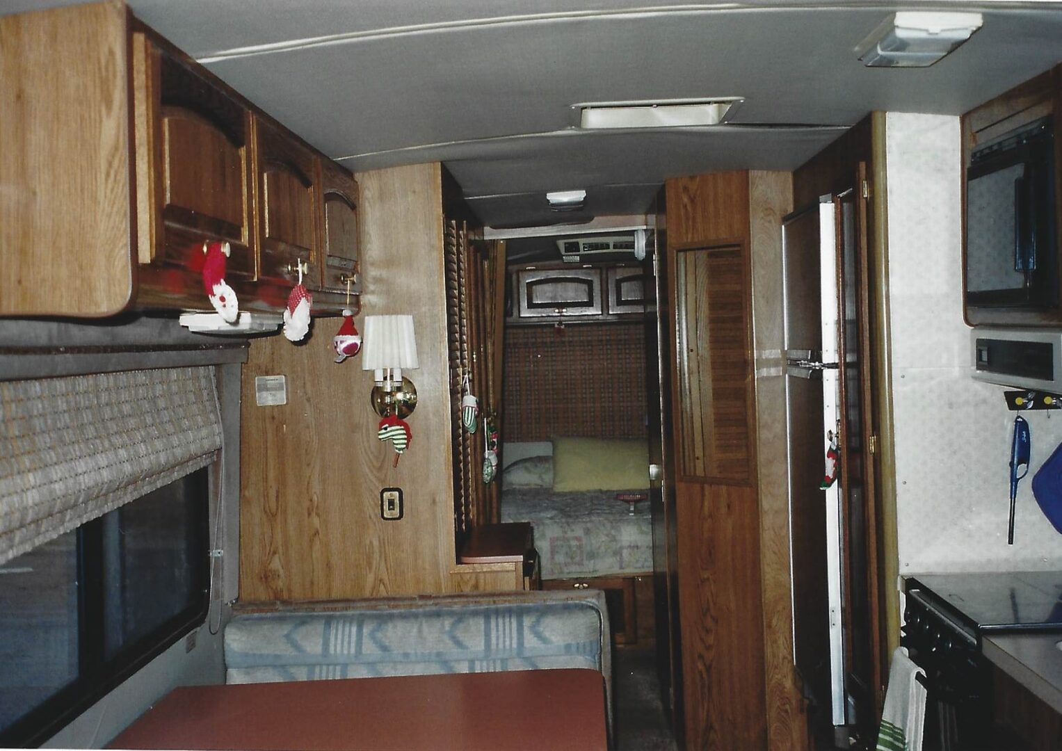 A small room with wood paneling and wooden cabinets.