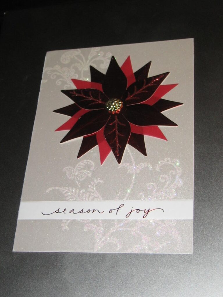 A card with a poinsettia on it.