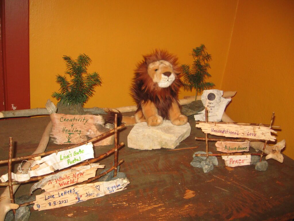 A stuffed lion sitting on top of rocks.