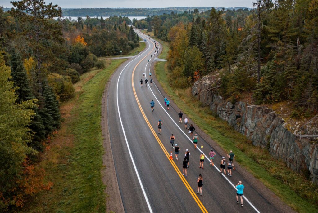 A group of people riding bikes down the road.