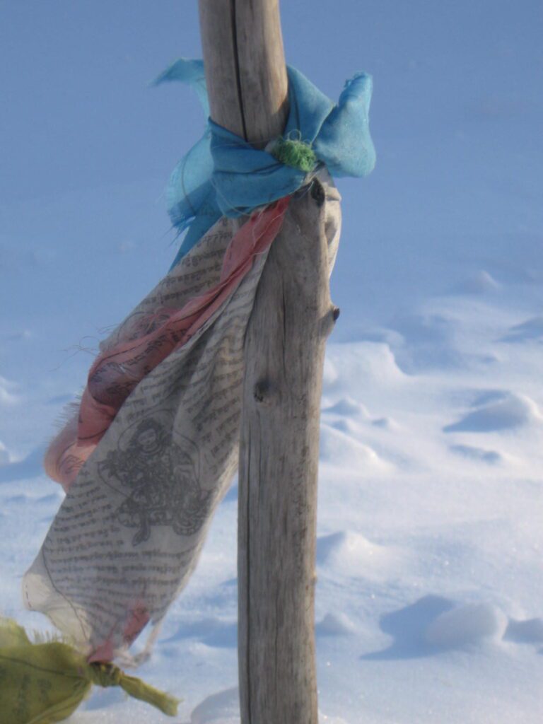 A person standing on top of a wooden pole.