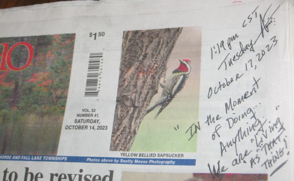 A newspaper with a bird on it and some writing.