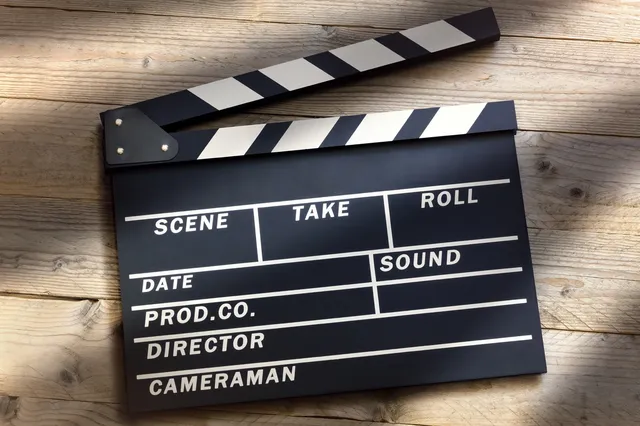 A black and white clapperboard sitting on top of a table.