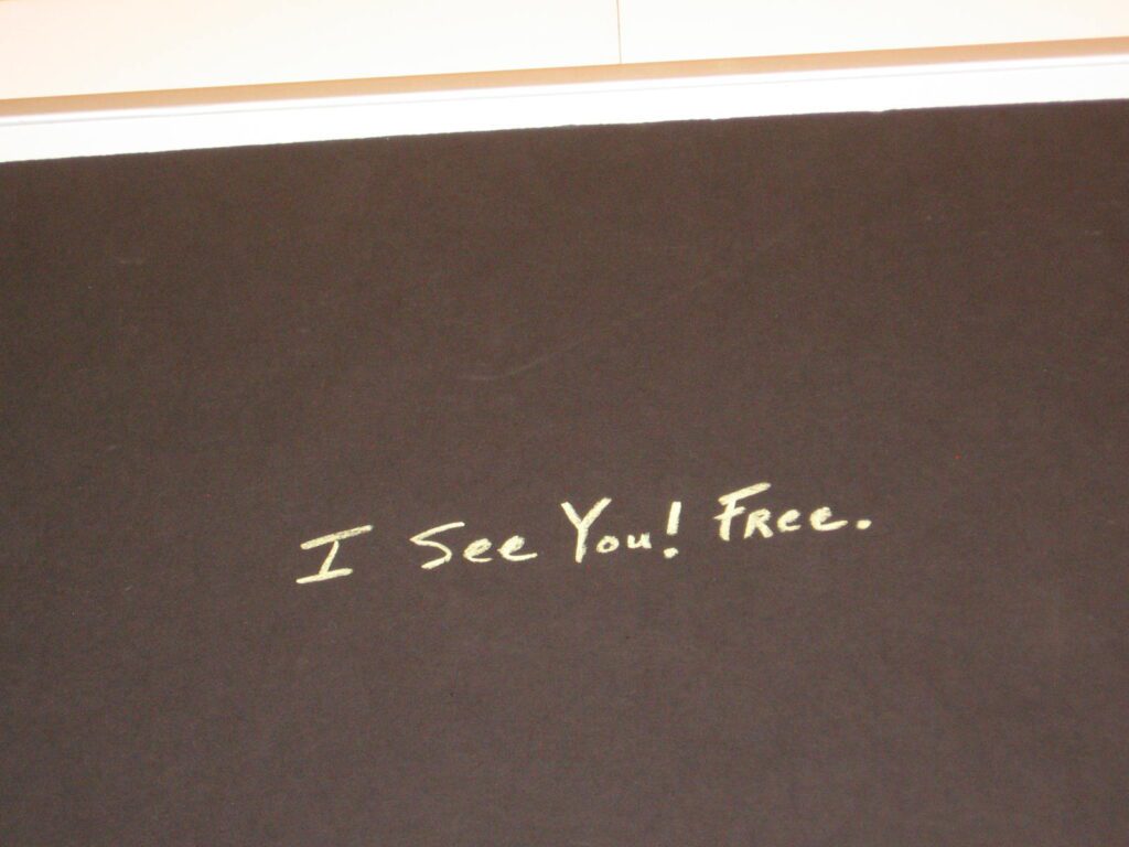 A close up of the words i see you ! face.