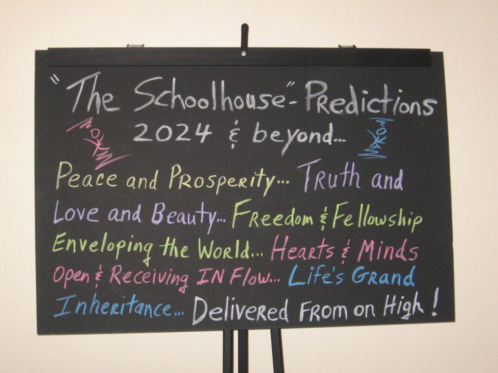 A chalkboard sign with the words " the schoolhouse predictions 2 0 2 4 & beyond ".