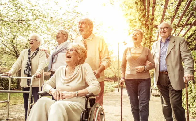 A group of people standing around in the sun.