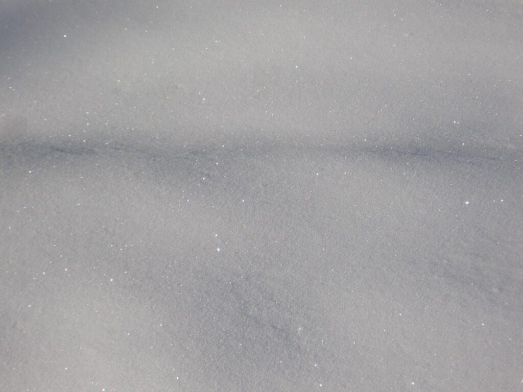 A white snow background with some kind of pattern