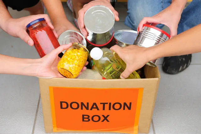 A box of food that is being opened to be given out.