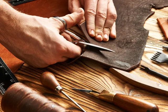 A person is working on some leather