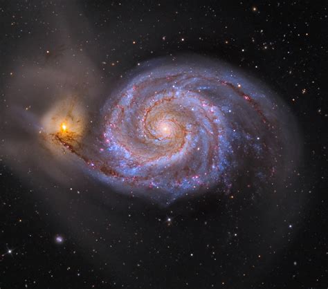 A spiral galaxy with a yellow star in the center.