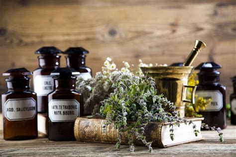 A table with some herbs and bottles on it