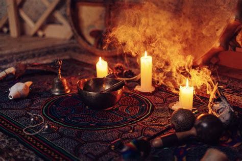 A table with candles and other objects on it.