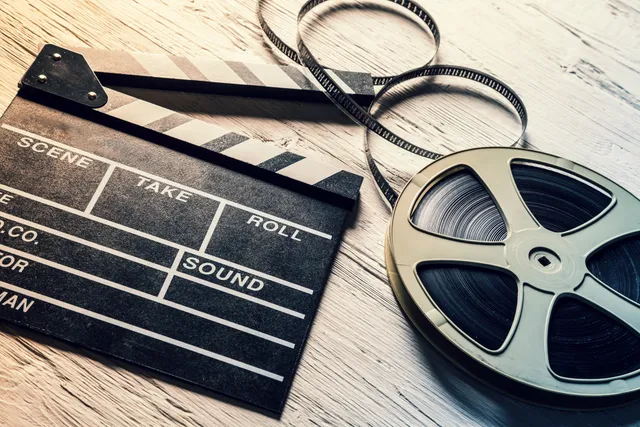 A film reel and some tape laying on the table.