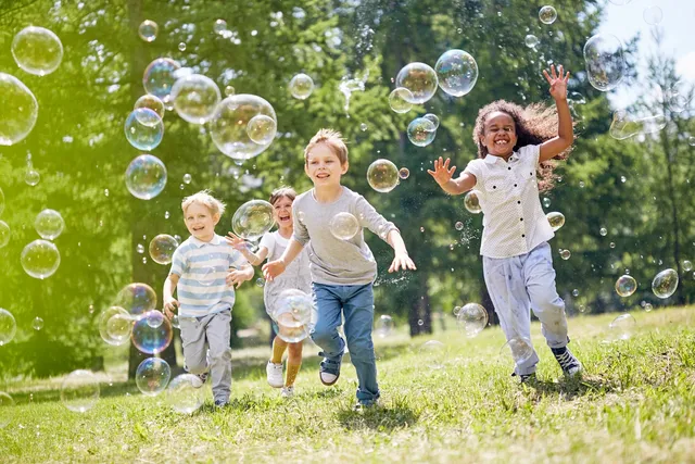 kids chasing bubbles